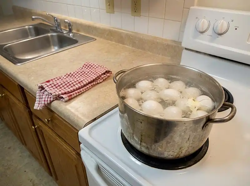 Ina Garten Egg Salad Recipe 4 twelve eggs simmering in the dented stainless pot, cloudy bubbling water, one shell cracked